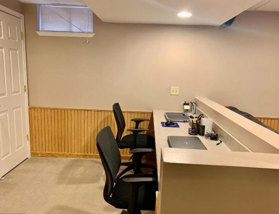 office chairs and built in desk in basement of new home sale