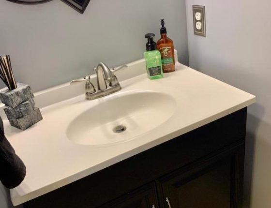 modern bathroom sink and cabinetry in new home for sale