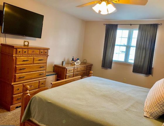 bedroom with dresser set and ceiling fan in new home for sale