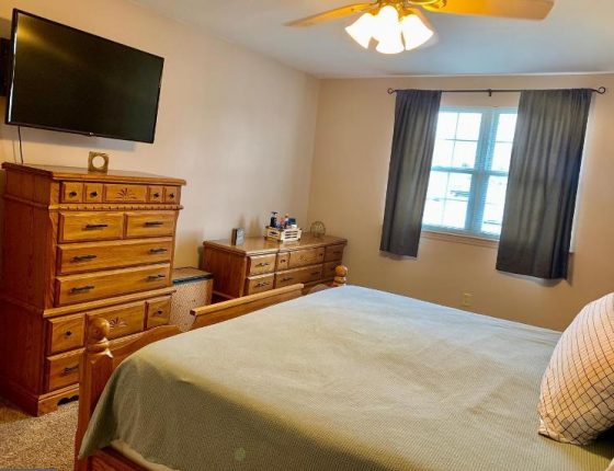 bedroom with dresser set and ceiling fan in new home for sale