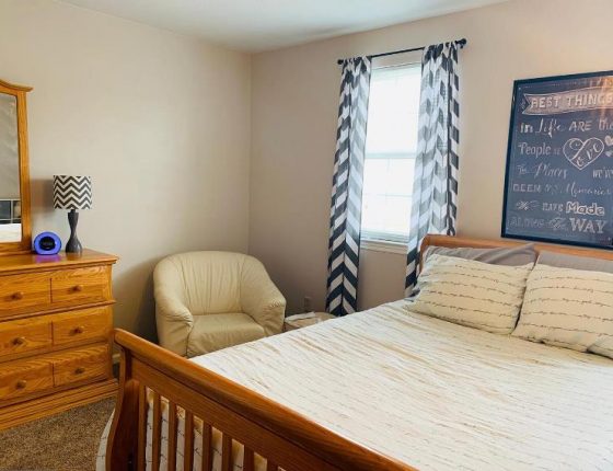 bed window and dresser in upstairs bedroom of new home for sale