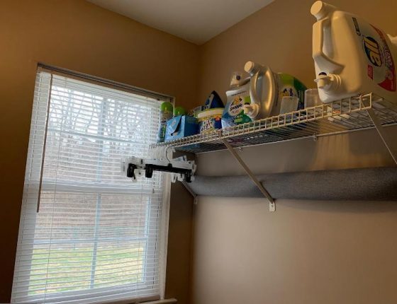 laundry detergent and cleaning supplies sitting on shelf next to window