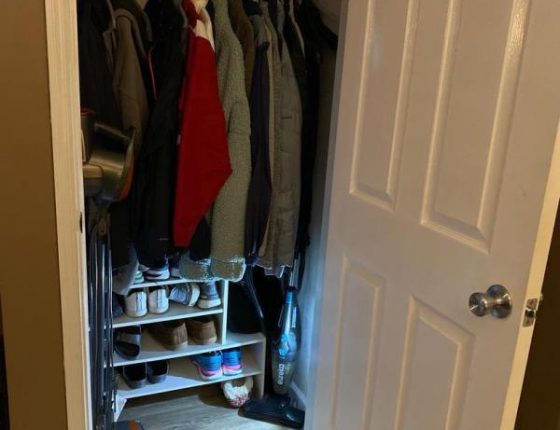 single closet filled with clothes and shoes in new home for sale