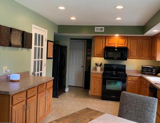 kitchen with green walls and white doors in new home sale