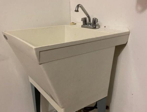 grey laundry room sink in new home for sale