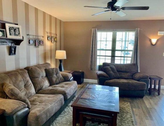 living room furniture and window in new home for sale