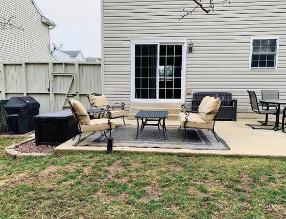 outdoor patio furniture sitting on carpet in front of sliding glass door