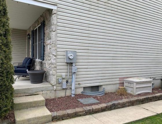 vinyl siding and utility gauges on side of new home for sale